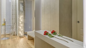 A modern bathroom with a glass shower enclosure, a white vanity with a mirror, and a bench. - Gian Giacomo Mora, 13 - Refined studio apartment downtown (Milan)