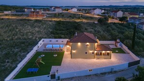 A modern house with a swimming pool, a patio, and a well-maintained lawn. - Villa Rustica Vrana Zadarvillas (Pakostane)