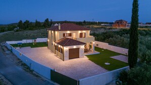 A modern two-story house with a well-maintained lawn and a paved driveway. - Villa Rustica Vrana Zadarvillas (Pakostane)