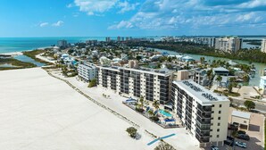 A coastal hotel with multiple floors, a beachside location, and a view of the ocean. - SUMMER DISCOUNT! Beachfront 2B/2B Vacation Condo Carlos Pointe 221. Amazing Views! EVERYTHING BRAND NEW! (Fort Myers Beach)