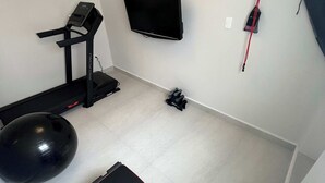 A compact home gym with a treadmill, exercise ball, and a bench. - Arquimedes Calm - Lovely 1BR in Polanco (Mexico City)