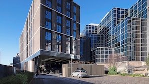 A modern building with a prominent entrance and a sign reading "Haymarket Yards". - Student Only Haymarket Yard (Edinburgh)
