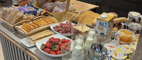 A breakfast buffet with various food items and beverages.