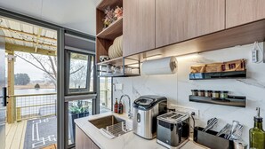 Une cuisine moderne équipée d’un évier, d’un grille-pain et d’une machine à café.