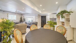 A dining area with a round table, chairs, and a ceiling fan. - Pool Table + Private Porch: Peaceful Apt in Belle (Belle)