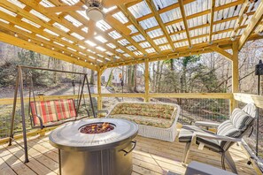 A covered deck with a fire pit, wicker furniture, and a swing set. - Gazebo, Fire Pit! Woodsy Cabin By Black Rock Mtn (Mountain City)