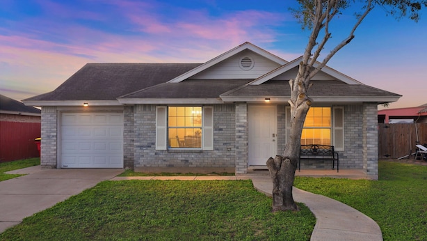 A single-story house with a garage, a front porch, and a well-maintained lawn. - Hot Tub! Dog-friendly Gem 6 Mi to Dtwn Brownsville (Brownsville)