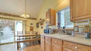 A kitchen with wooden cabinets, a microwave, and a sink. - Family Nature Escape! South Branch Haven w/ Deck (South Branch)