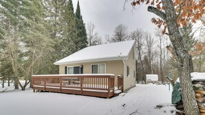 A single-story house with a snow-covered deck and a small porch. - Family Nature Escape! South Branch Haven w/ Deck (South Branch)