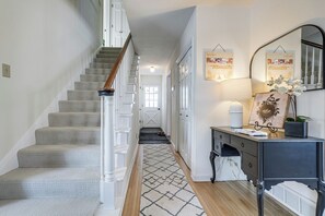 A staircase with carpeted steps and white railings, leading to a door. - Spacious Home Near Lake Bemidji With Game Room! (Bemidji)