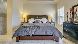 A bedroom with a large bed, two bedside lamps, a dresser, and a mirror. - Mountain-view Retreat Near Organ Wilderness Trails (Las Cruces)