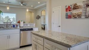 A modern kitchen with granite countertops, stainless steel appliances, and pendant lighting. - Mountain-view Retreat Near Organ Wilderness Trails (Las Cruces)