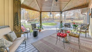 A covered porch with a wooden ceiling, a ceiling fan, and a view of a road and trees. - Beautiful & Unique Farmhouse 15 Mi to Saratoga (Fort Edward)