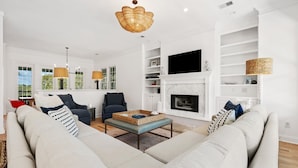 A living room with a sofa, armchairs, a coffee table, and a fireplace. - Dieu Not Disturb 5 Bedroom Home (Georgetown)