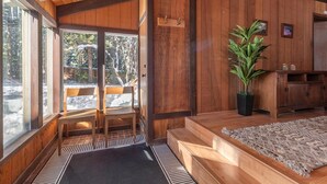 A wooden interior with a bench, a potted plant, and a rug. - Dollar Point - Observation Dr. 3 Bedroom Home (Tahoe City)