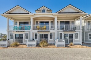 A two-story house with a balcony, a covered porch, and a driveway. - 1947 S Fletcher 2 Bedroom Townhouse (Fernandina Beach)