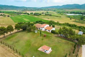 A rural property with a main house, a smaller structure, and a solar panel.