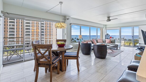 A spacious living area with a balcony, large windows, and a view of the ocean. - Ilikai Hotel Condo with Ocean, Lagoon & Fireworks Views (Honolulu)