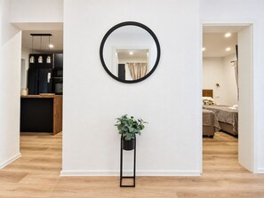 A modern interior with a kitchen, a mirror, and a potted plant. - Apartment Perla (Vir)