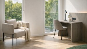 A modern room with a sofa, a desk, and a view of trees through large windows. - Hotel Ogar Tomelloso (Tomelloso)