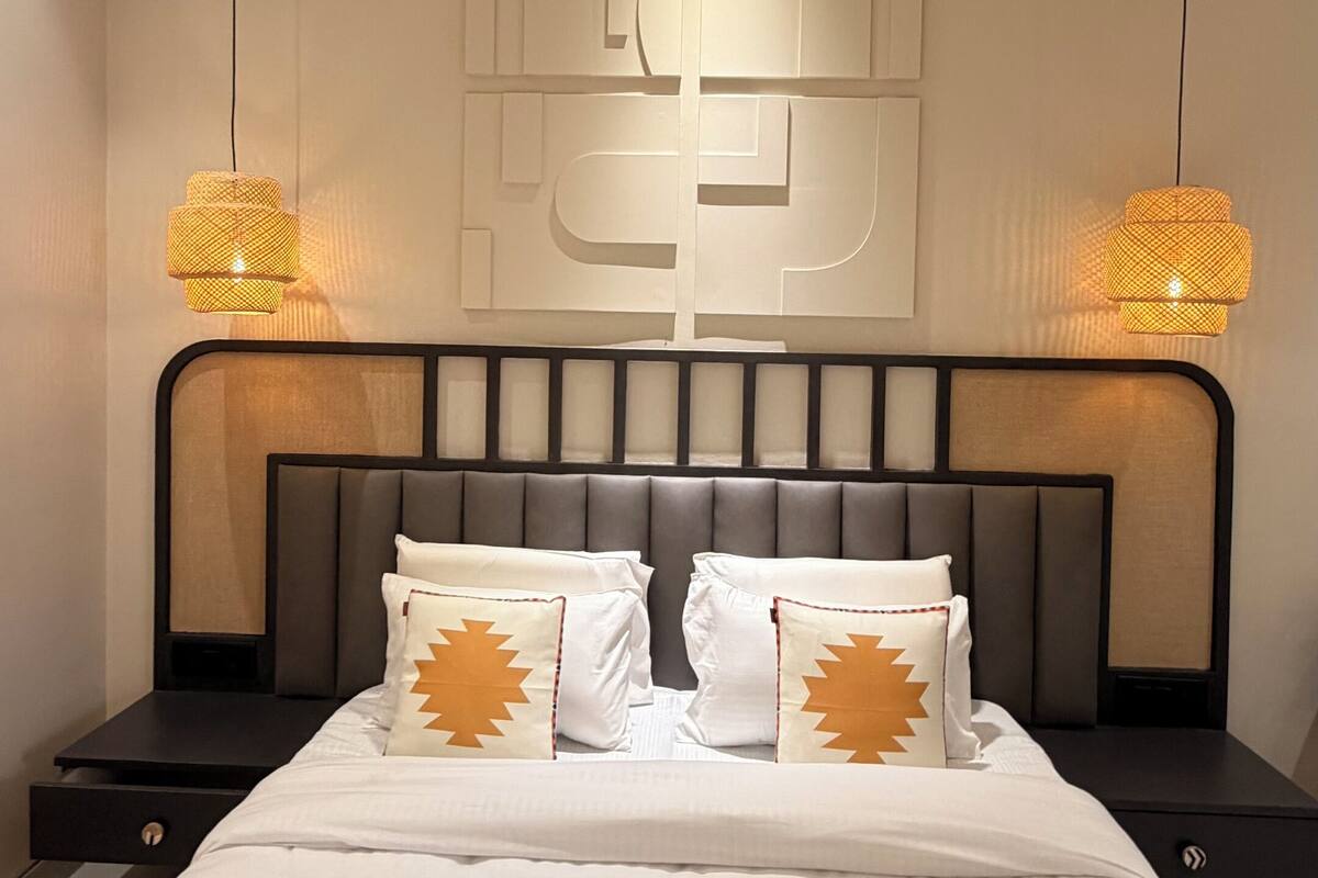 Ein modernes Schlafzimmer mit einem großen Bett, zwei Nachttischen und einem einzigartigen Wandbild.