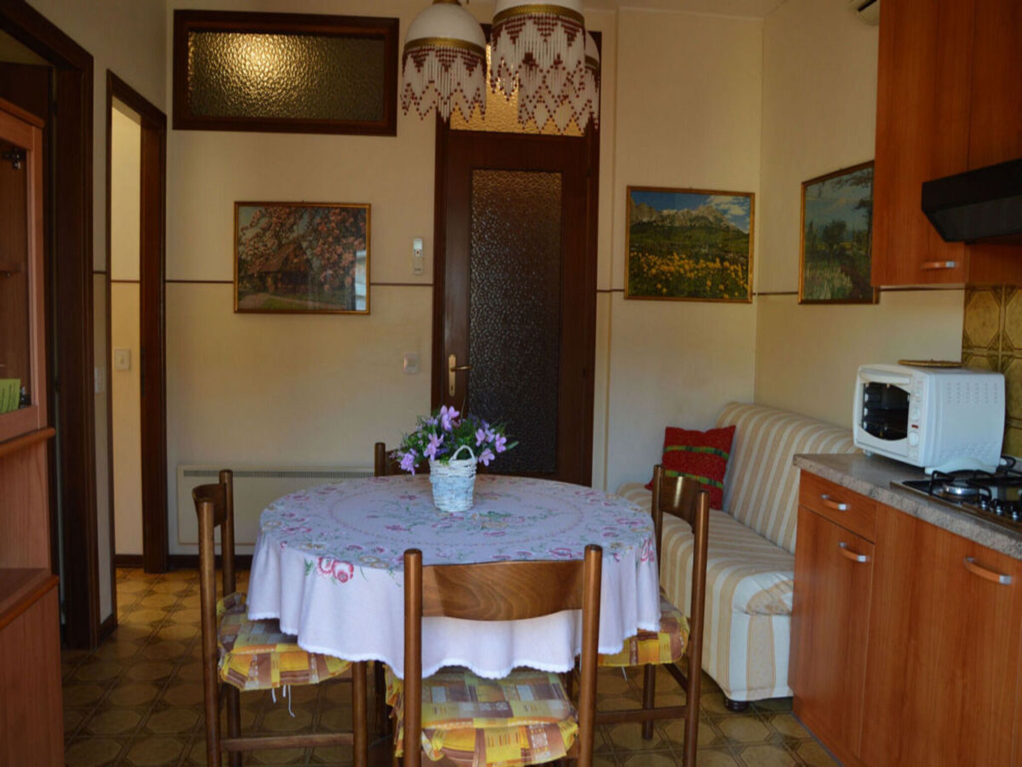 Un comedor acogedor con una mesa redonda, sillas y una pequeña planta en maceta.
