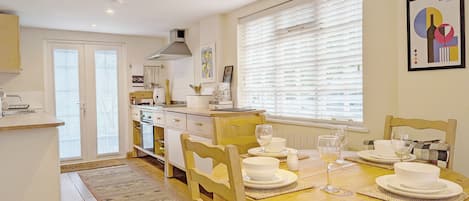 Fridge, toaster, cookware/dishes/utensils, dining tables