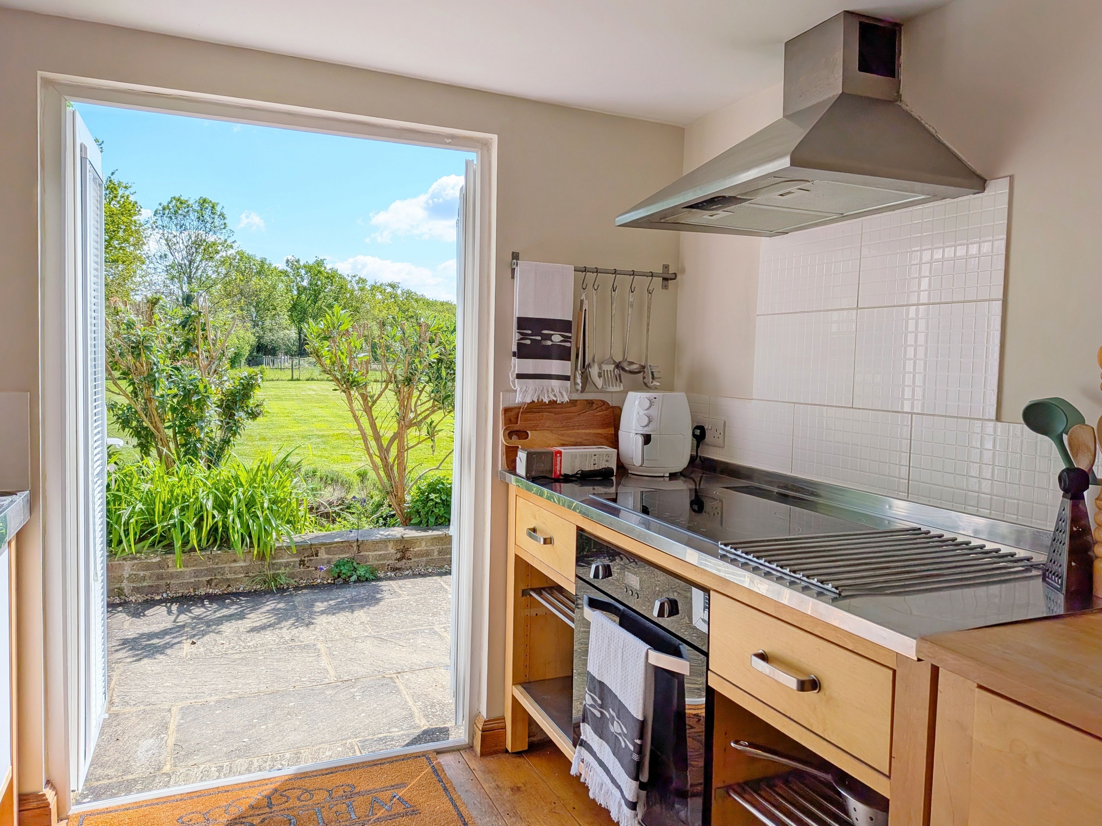 Fridge, toaster, cookware/dishes/utensils, dining tables