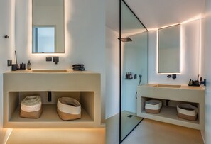 A modern bathroom with a large mirror, built-in storage, and a minimalist design. - Paros Villa Skylines Estate II (Paros)