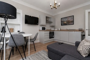 A modern kitchen with white cabinets, a microwave, and a coffee maker. - Sleeps 5 | 2 Bedrooms | Hawick (Hawick)