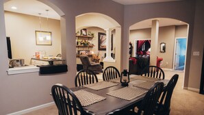 A dining area with a dark wooden table, black chairs, and beige walls. - Forget your worries and enjoy some peace in the beautiful Lancaster Guest House. (New Holland)