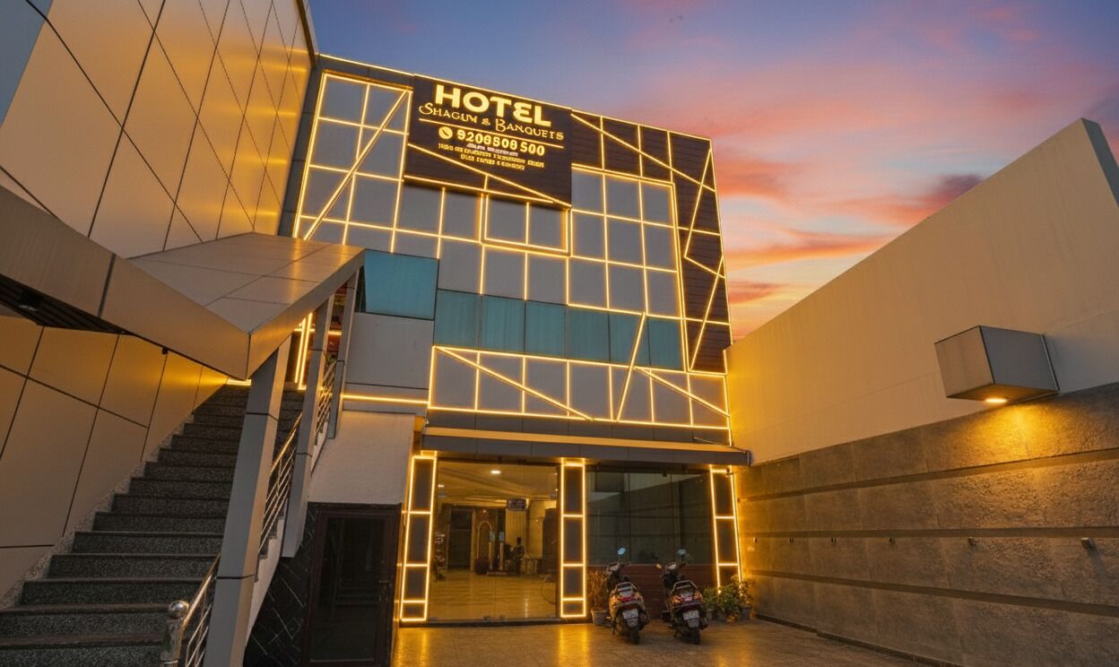 A modern hotel with a geometric facade and illuminated signage.