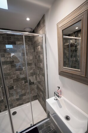 Shower, hair dryer, towels, soap