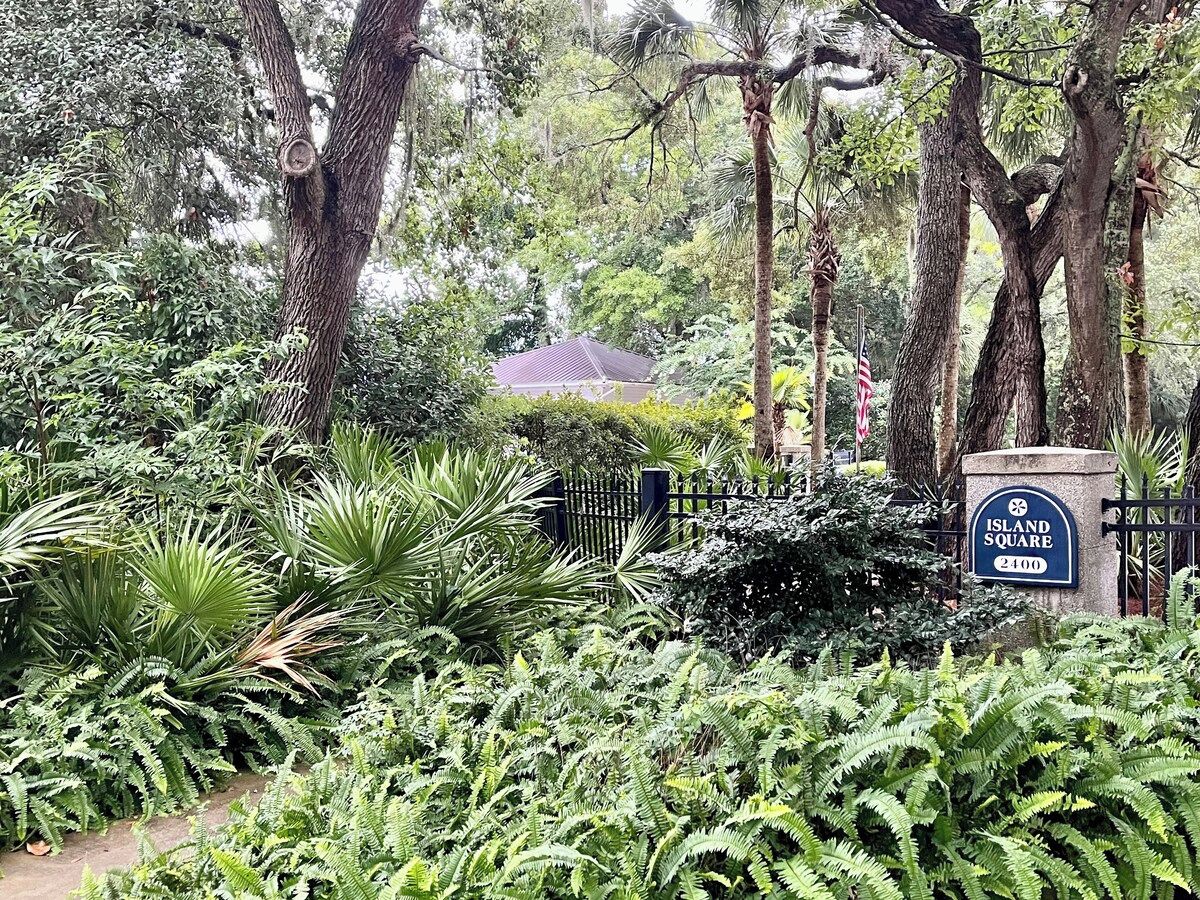 A lush garden with a sign reading 'Island Square 2400'.