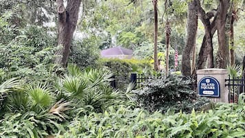 A lush garden with a sign reading 'Island Square 2400'.