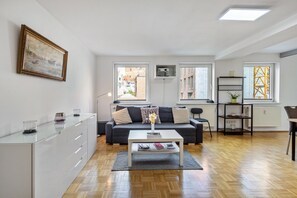 A modern living room with a sofa, coffee table, and a painting on the wall. - Dream on the Old Town Island (Lübeck)