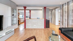 A modern living room with a glass coffee table, a sofa, and a TV. - Apartment 'Seestern' with Balcony and Wi-Fi (Wester-Ohrstedt)