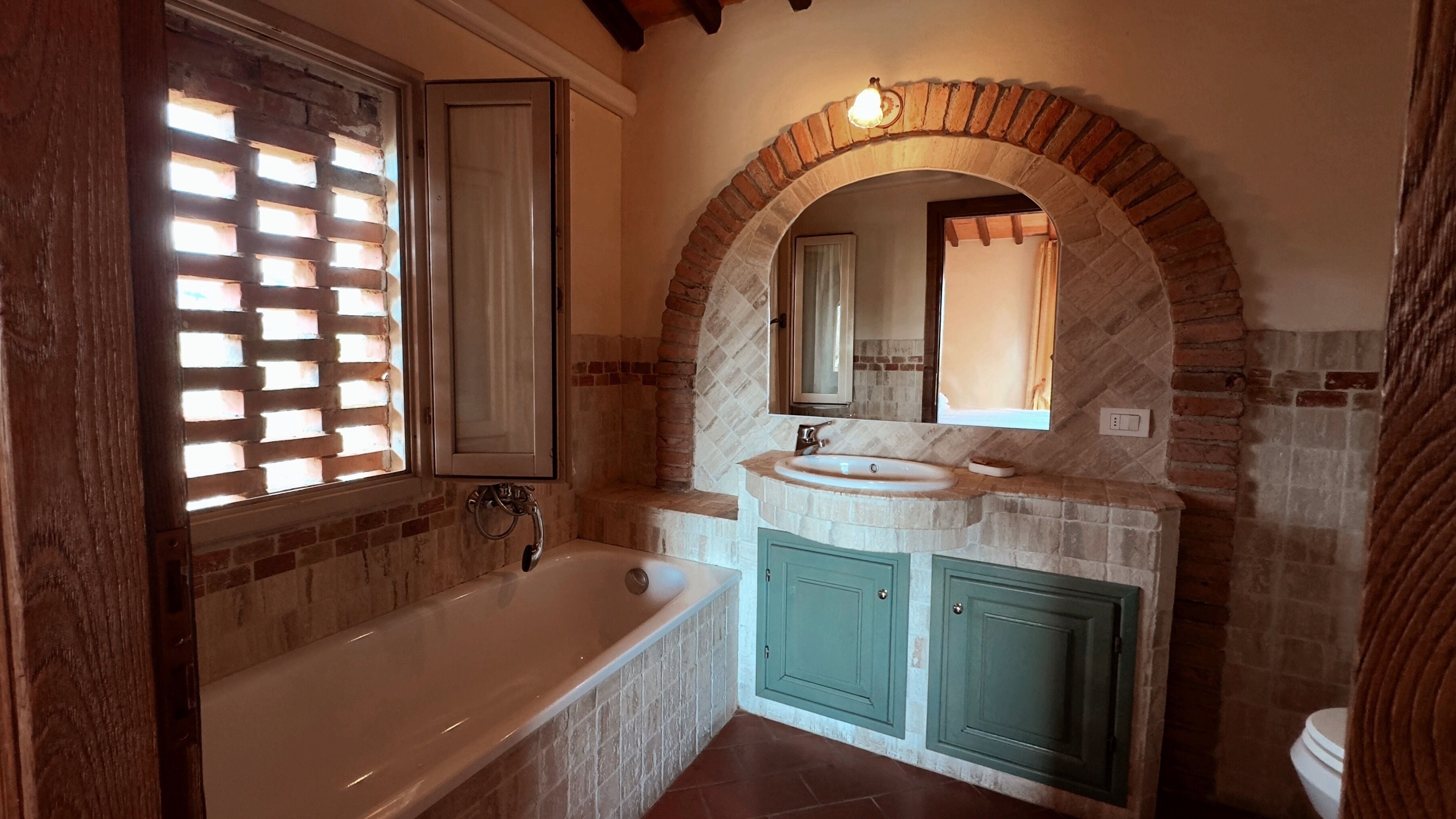 A bathroom with a freestanding bathtub, a vanity with a sink, and a mirror above the sink.