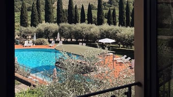 Seasonal outdoor pool, open 9:00 AM to 8:00 PM, pool umbrellas
