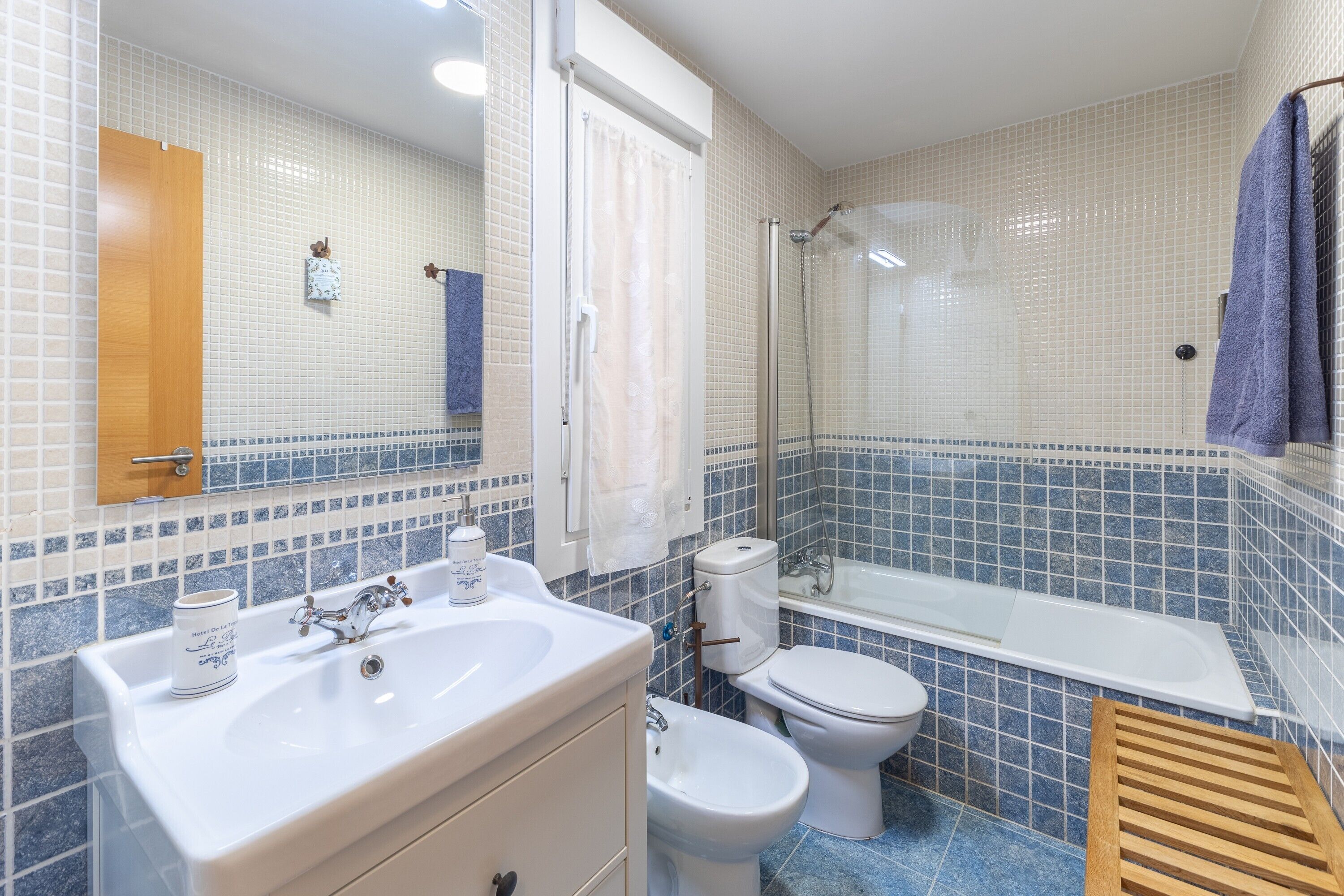 Un baño con lavamanos, inodoro y ducha.