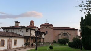 Un bâtiment traditionnel doté d’un dôme central et d’une structure adjacente plus petite, recouverte d’un toit en tuiles.