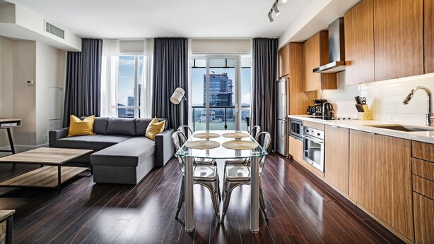 A modern apartment with a dining area, kitchen, and living space. - Executive 1BR at 300 Front St W | Balcony & Gym (Toronto)