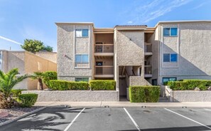 A multi-story apartment building with a parking lot in front. - Amazing golf course and sunset views in Old Town Scottsdale (Scottsdale)