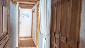 Ein schmaler Korridor mit Holzausbau und Fliesenboden.
