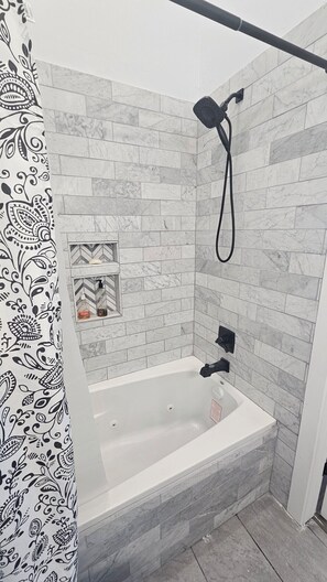 Jetted bath, towels, soap, toilet paper