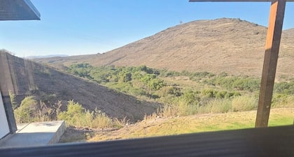 Serene large bedroom with private entrance, bathroom, and thermostat.