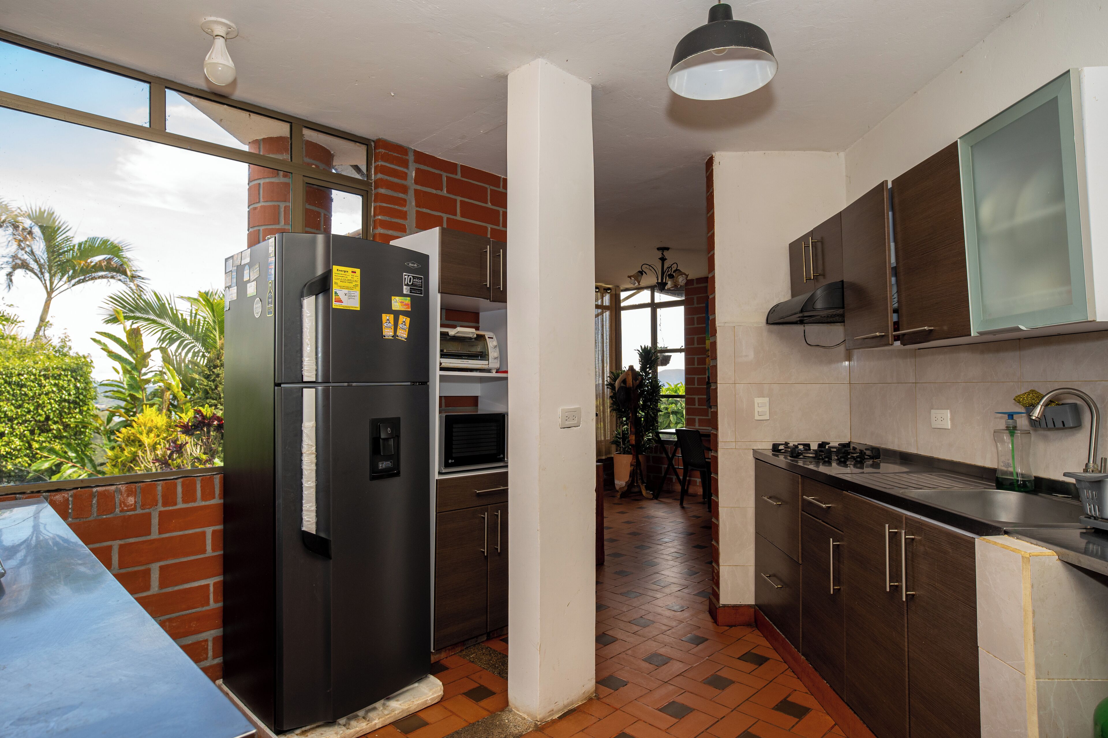 A modern kitchen with a refrigerator, stove, and sink.
