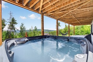 A hot tub with a wooden roof structure and a view of a mountainous landscape. - Spa, Pool Table, Ultimate Comfort | OSE Le Refuge (Saint-Côme)