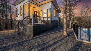 A modern two-story house with a covered deck and a swimming pool. - New! Private Heated Pool, Hot Tub, Game Room, Fire Pit & Bunk Room - Near Trails (Broken Bow)