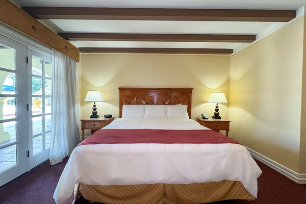 Unwind in crisp linens beneath warm, rustic ceiling beams.